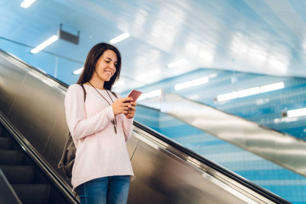 istock Texting on an escalator to metro station 1276435188