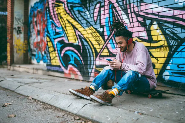Photo of Graffiti artist listens to music