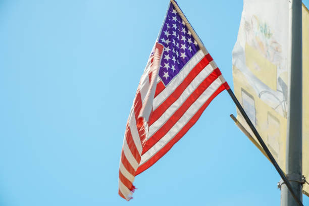 istock American flag on blue sky background close up 1276438699