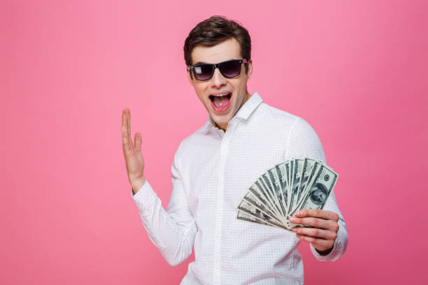 istock Excited man holding money. 1276438902