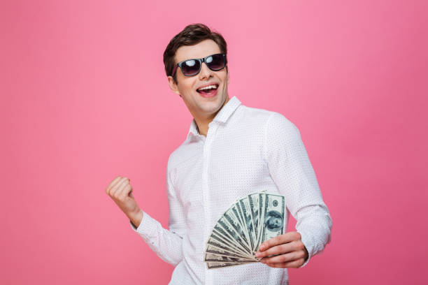 istock Happy handsome man holding money make winner gesture. 1276439135
