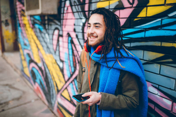 istock Young man with dreadlocks enjoys music 1276439449