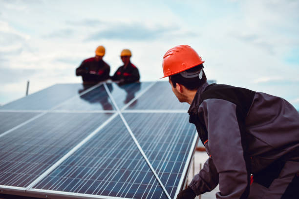 istock Workers Measuring Power Distribution Across Solar Panel Diagonally 1276441566