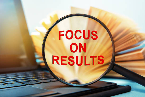 istock Text Focus on results on magnifying glass. Laptop computer and book with a magnifying glass. 1276442346