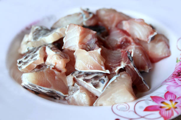 istock Tilapia fillet in plastic container close up isolated on white background 1276443144