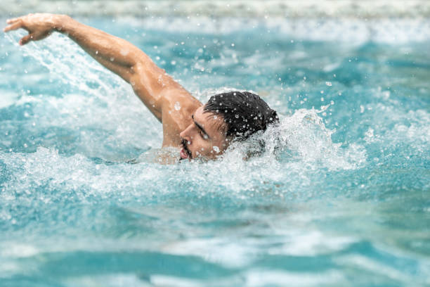 istock Man swimming crawl in the pool 1276443857