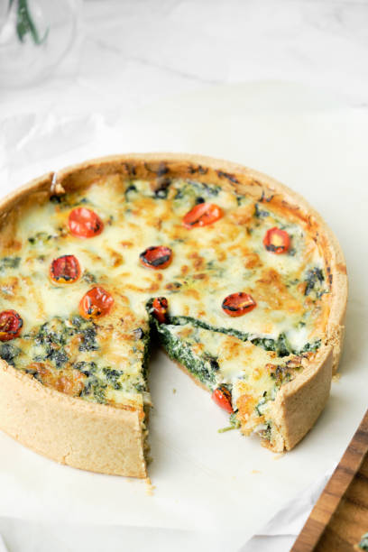 istock Homemade cheesy spinach quiche for brunch. set on white cafe table background. 1276444118