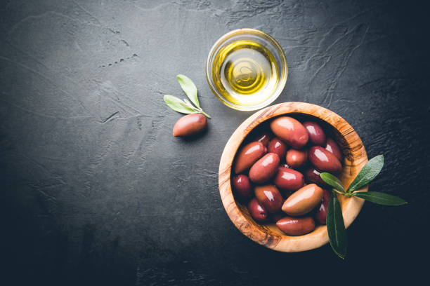 istock Black olives and olive oil 1276446665
