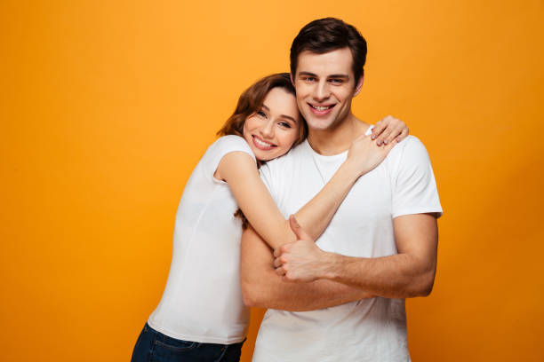 istock Pleased lovely couple posing together and hugging 1276446852