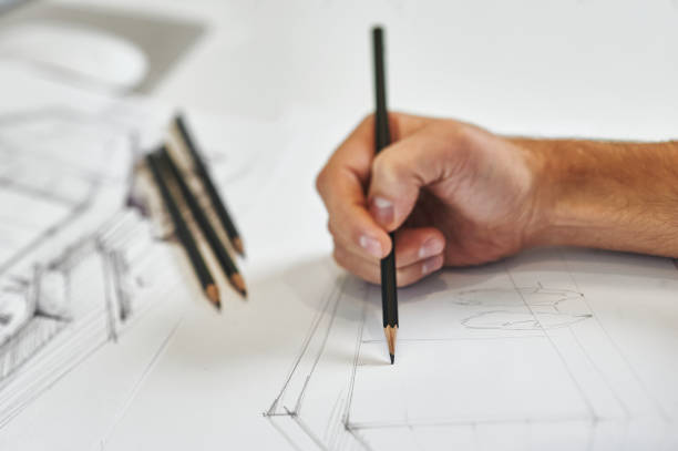 istock Creative architect and graphic designer works on hand drawing architectural blueprint with black pencil 1276448625