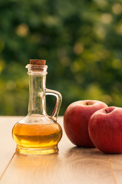 istock Apple vinegar in glass bottle and fresh red apples 1276449895