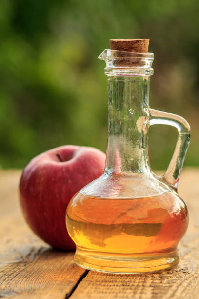istock Apple vinegar in glass bottle and fresh red apple 1276450220