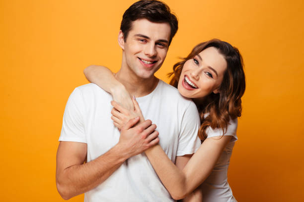 istock Portrait of a smiling young couple hugging 1276451274