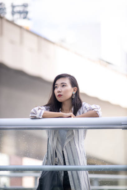 istock Young business woman relaxing on pedestrian deck 1276451390