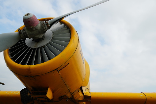 Close up colour image of a propeller of a plane with sky in background and copy space.