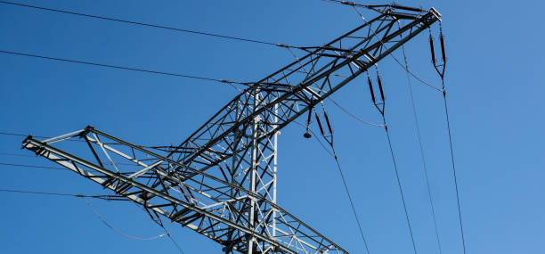 istock Panorama high voltage pylon isolated blue background 1276452606