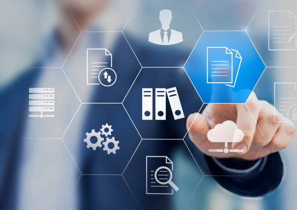 istock Document Management System (DMS) used to store, search and manage review process and users for corporate files and information in enterprise. Concept with business manager pointing to icons. 1276453195