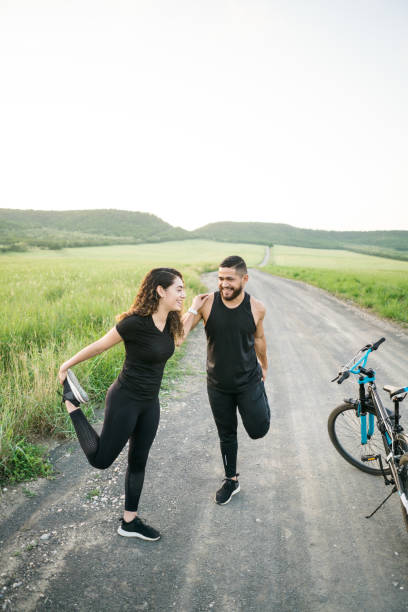 istock Latin couple stretching legs and holding each other 1276453415