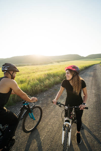 istock Happy couple looking at each other on bikes 1276453456