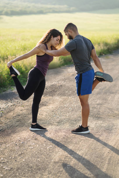 istock Latin couple holding each other and stretching legs 1276453479