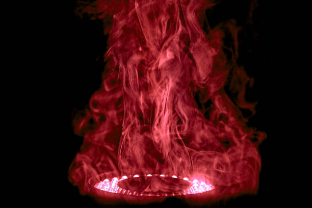 A cloud of smoke is illuminated by an LED ring light.