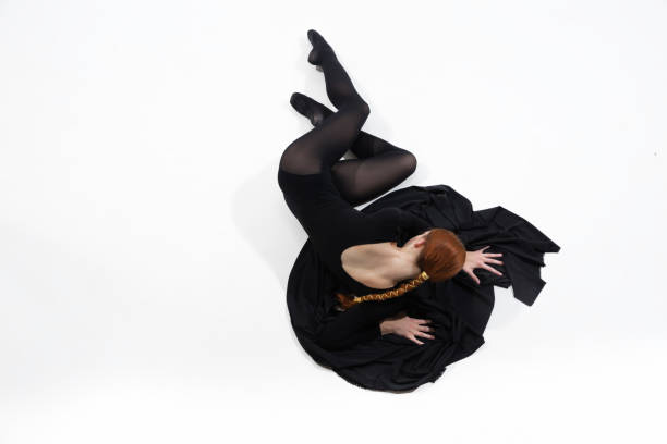 istock Young and graceful ballet dancer in minimal black style isolated on white studio background 1276454971