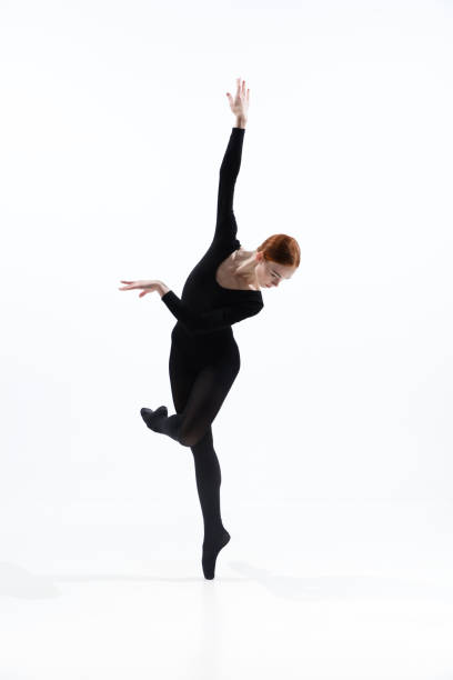 istock Young and graceful ballet dancer in minimal black style isolated on white studio background 1276454991