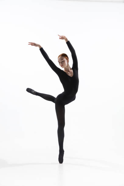 istock Young and graceful ballet dancer in minimal black style isolated on white studio background 1276455018