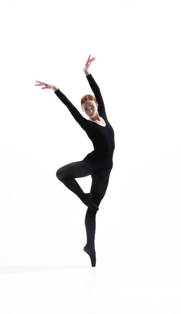 istock Young and graceful ballet dancer in minimal black style isolated on white studio background 1276455061