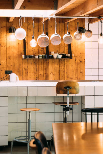 istock Kitchen with barn wood, white tiles, dining table and copper pans. Vintage modern vibe 1276455106