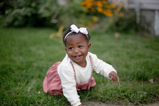 istock Cute baby girl on the grass 1276455802