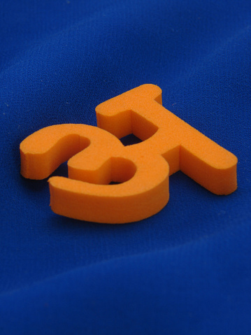 A image showing starting 4 alphabets of Indian Hindi language on blue cloth background giving high contrast to the letters