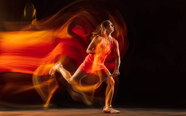 istock Professional female tennis player isolated on black studio background in mixed light 1276457188