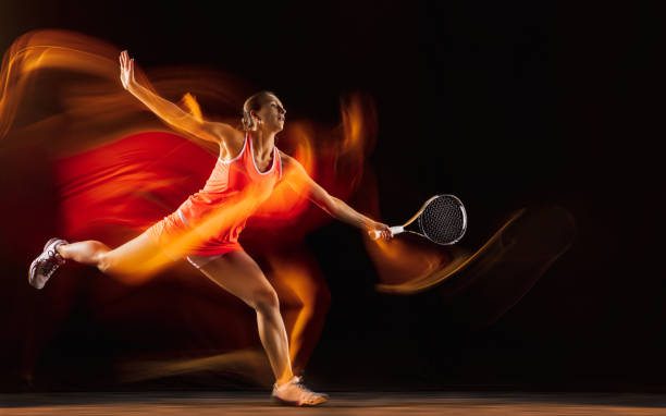 istock Professional female tennis player isolated on black studio background in mixed light 1276457211