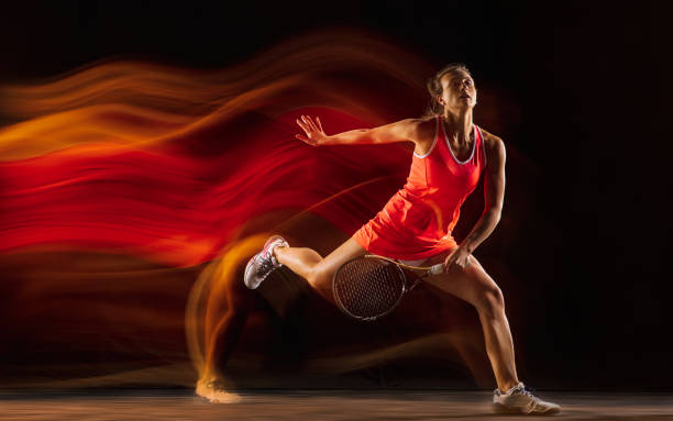 istock Professional female tennis player isolated on black studio background in mixed light 1276457222