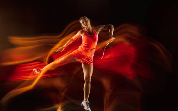 istock Professional female tennis player isolated on black studio background in mixed light 1276457241