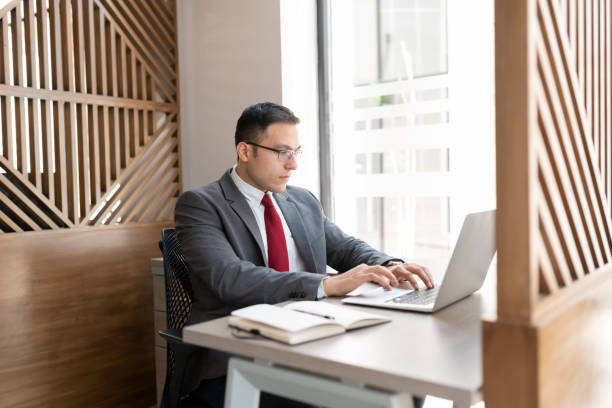 istock Businessman working on laptop at his desk 1276457388