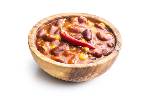 Chili con carne. Mexican food with beans in wooden bowl isolated on white background.