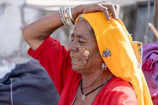 Pushkar, India - nov 13, 2018 : Indian woman in the desert Thar during Pushkar Camel Mela near holy city Pushkar, Rajasthan, India