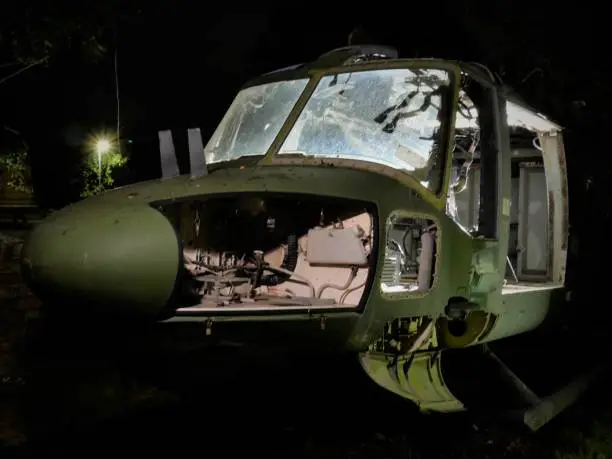 Photo of disused abandoned Helicopter grounded at night with daylight quality lighting to show nose body and component parts