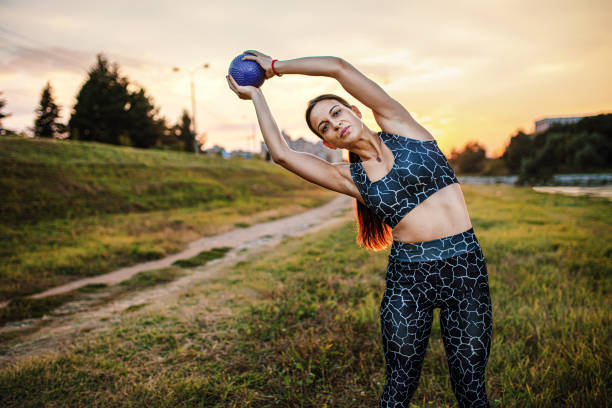 istock Modern and fit flexible girl exercising by a river 1276462288