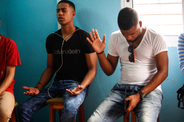Young cuban Protestants Havana, CUB - June 16, 2018: Young Protestants and Evangelicals pray together in a room. protestantism photos stock pictures, royalty-free photos & images