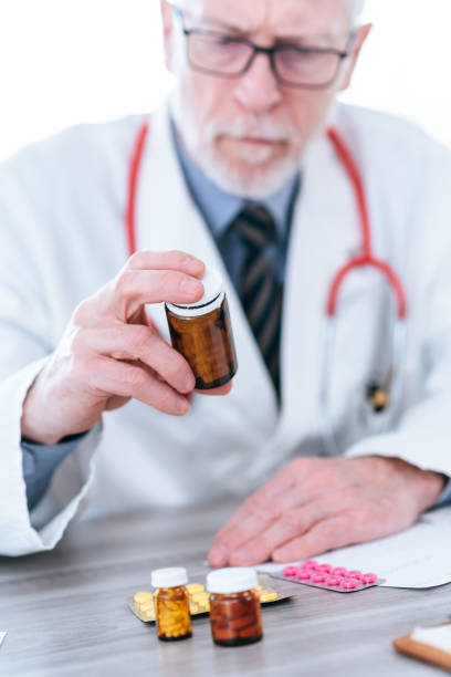 istock Doctor looking at a bottle of pills 1276463530