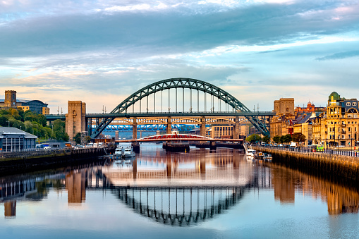 The bridges between Gateshead and Newcastle-upon-Tyne on the River Tyne lit by a stunning late summer sunrise.