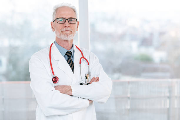 istock Senior doctor with arms crossed 1276464808