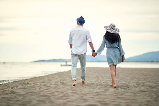 istock Young couple in love enjoying the beach 1276471610