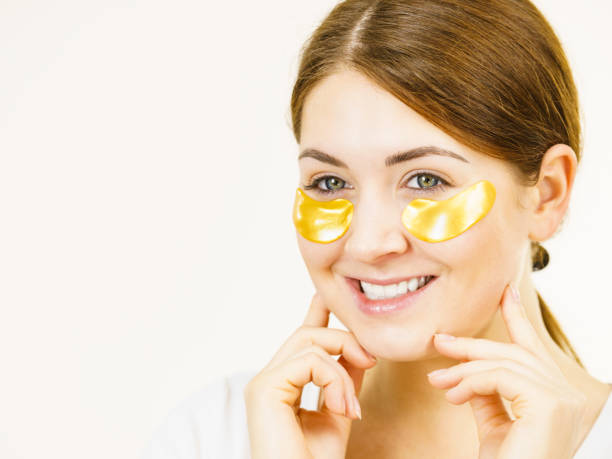 istock Woman with gold patches under eyes 1276471628
