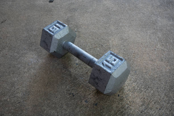 istock A Silver Fifteen Pound Dumbbell on Concrete 1276472904