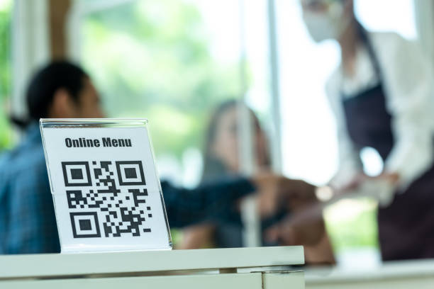 QR Code for online menu touchless activity in reopen restaurant with two customer and a staff in background QR Code for online menu touchless activity in reopen restaurant with two customer and a staff in background qr code photos stock pictures, royalty-free photos & images