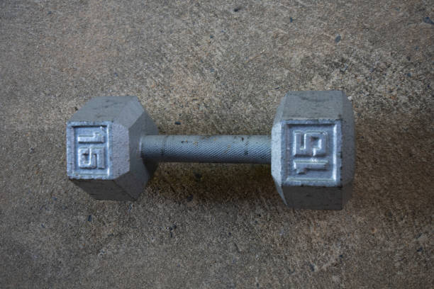istock A Silver Fifteen Pound Dumbbell on Concrete 1276473029